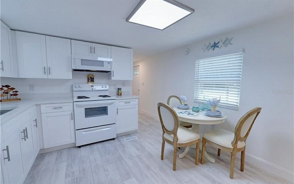 8164 East Turner Camp Road Inverness, FL 34453 - Photo 11 of 39 a view of kitchen with cabinets table and chairs