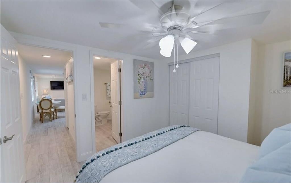 8164 East Turner Camp Road Inverness, FL 34453 - Photo 18 of 39 a bedroom with a bed and a chandelier