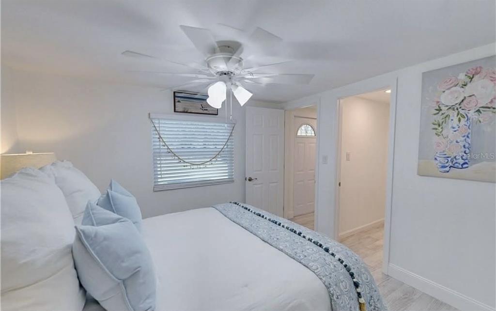 8164 East Turner Camp Road Inverness, FL 34453 - Photo 19 of 39 a bedroom with a bed and a chandelier