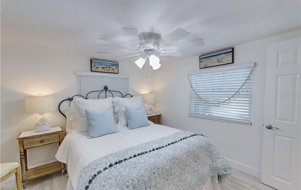 8164 East Turner Camp Road Inverness, FL 34453 - Photo 20 of 39 a bedroom with a bed and a chandelier