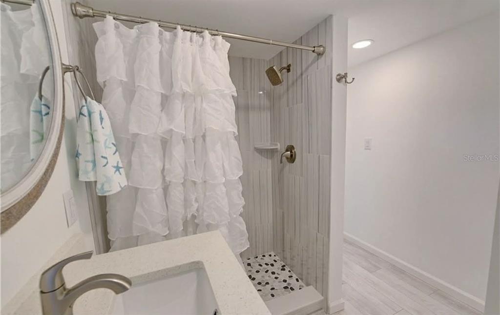 8164 East Turner Camp Road Inverness, FL 34453 - Photo 22 of 39 a bathroom with a shower curtain and a sink