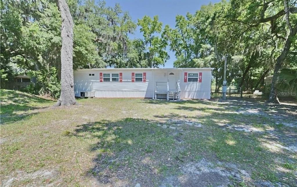 8164 East Turner Camp Road Inverness, FL 34453 - Photo 29 of 39 a view of a house with a yard