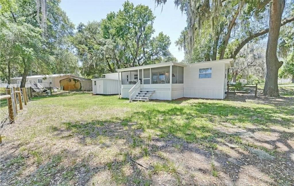 8164 East Turner Camp Road Inverness, FL 34453 - Photo 31 of 39 a view of a house with a yard and sitting area
