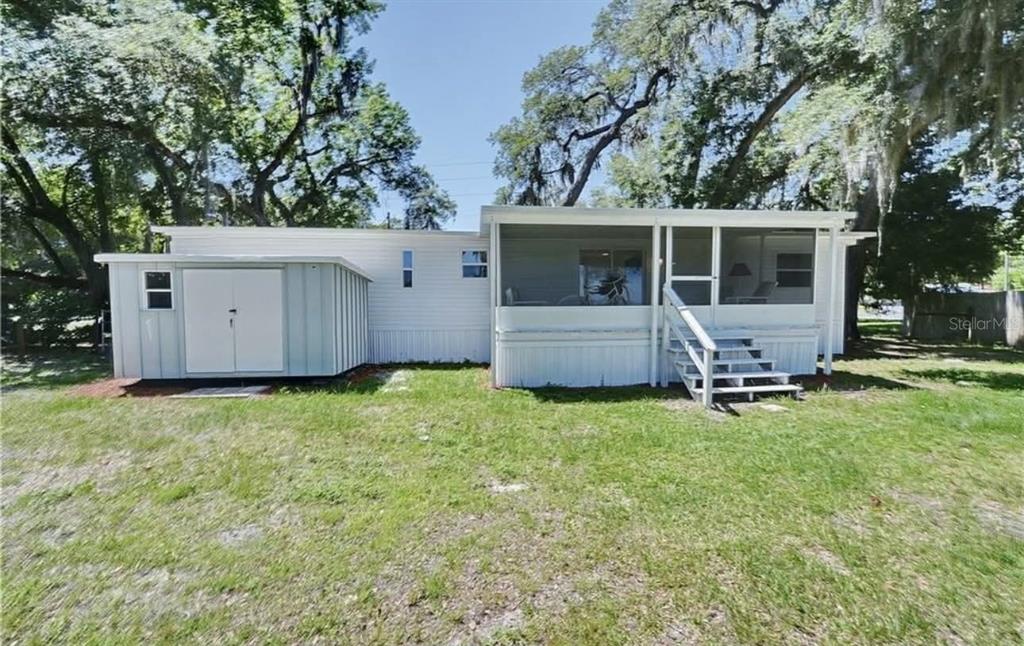 8164 East Turner Camp Road Inverness, FL 34453 - Photo 4 of 39 a view of house with backyard space and garden