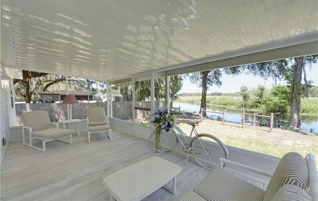 8164 East Turner Camp Road Inverness, FL 34453 - Photo 5 of 39 a living room with patio furniture and a large window