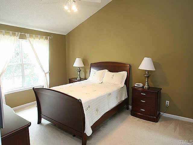 2504 Constitution Drive Raleigh, NC 27615 - Photo 6 of 9 a bedroom with a bed and a tv