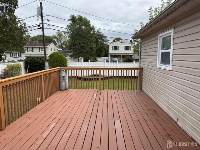a view of a wooden deck with a yard