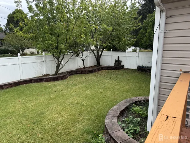 a view of a backyard with large trees