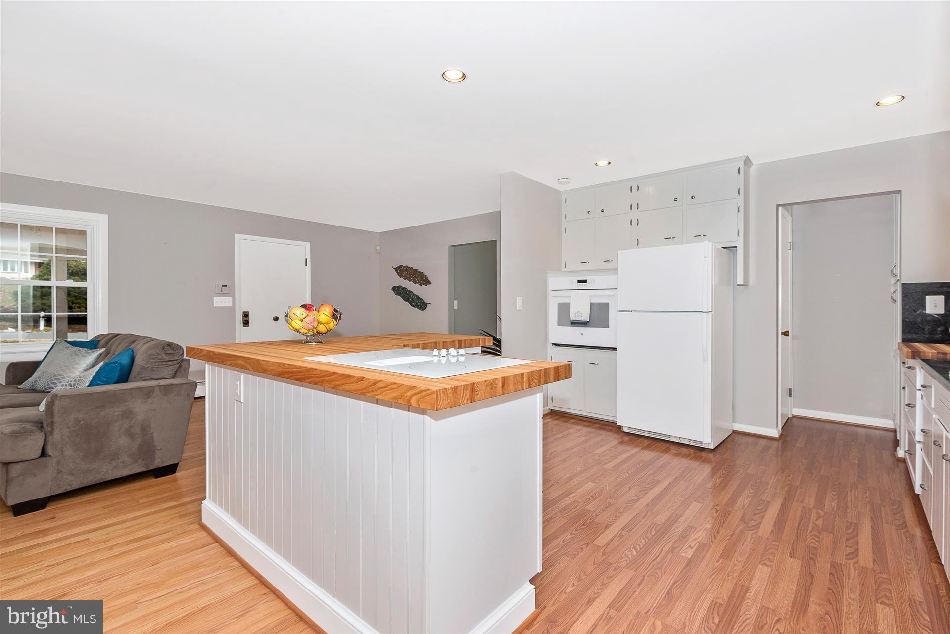 9416 Emory Grove Road Gaithersburg, MD 20877 - Photo 11 of 30 a kitchen with stainless steel appliances granite countertop a refrigerator a stove a sink and white cabinets with wooden floor