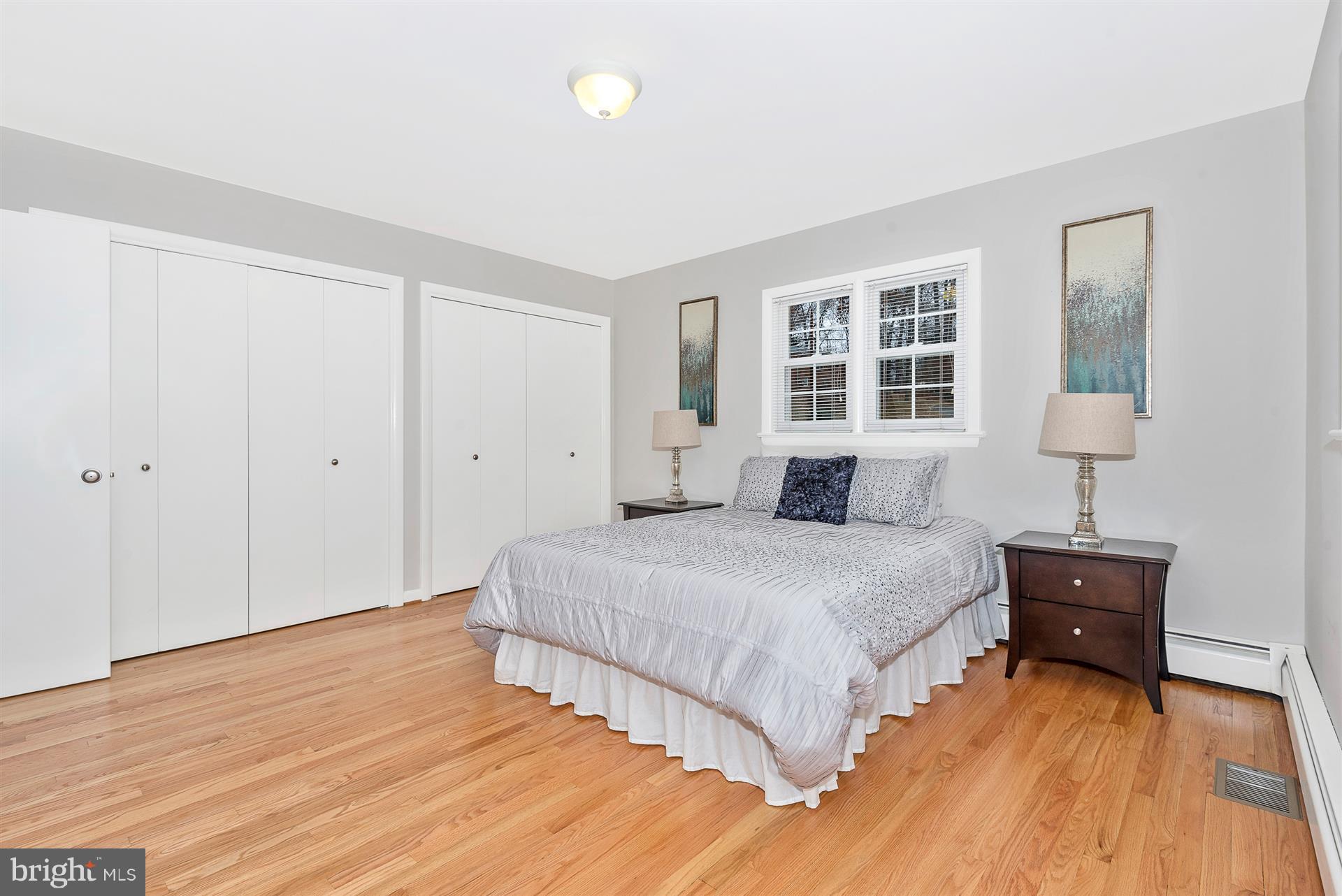 9416 Emory Grove Road Gaithersburg, MD 20877 - Photo 25 of 30 a spacious bedroom with a bed and a lamp