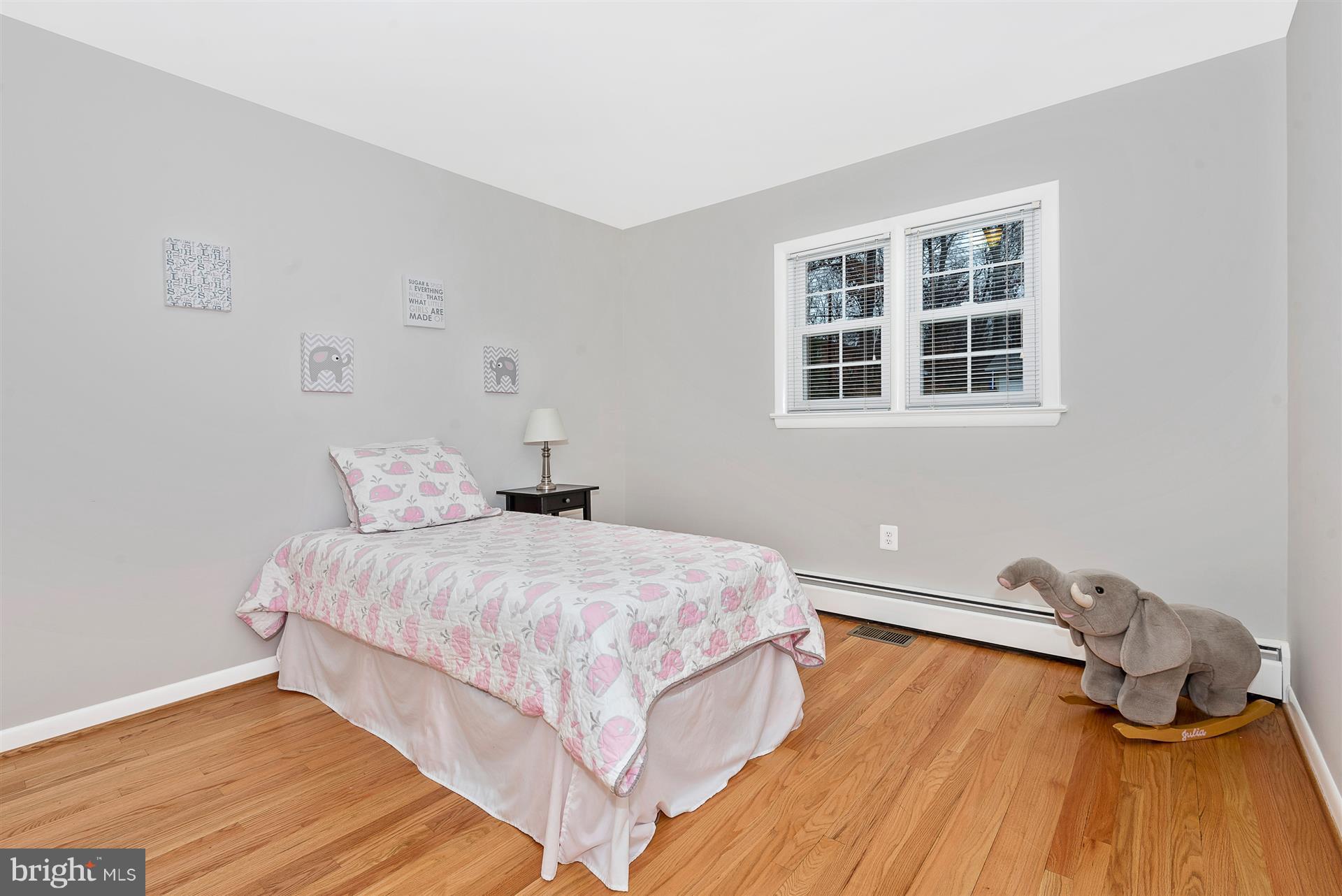 9416 Emory Grove Road Gaithersburg, MD 20877 - Photo 26 of 30 a bedroom with a bed and wooden floor