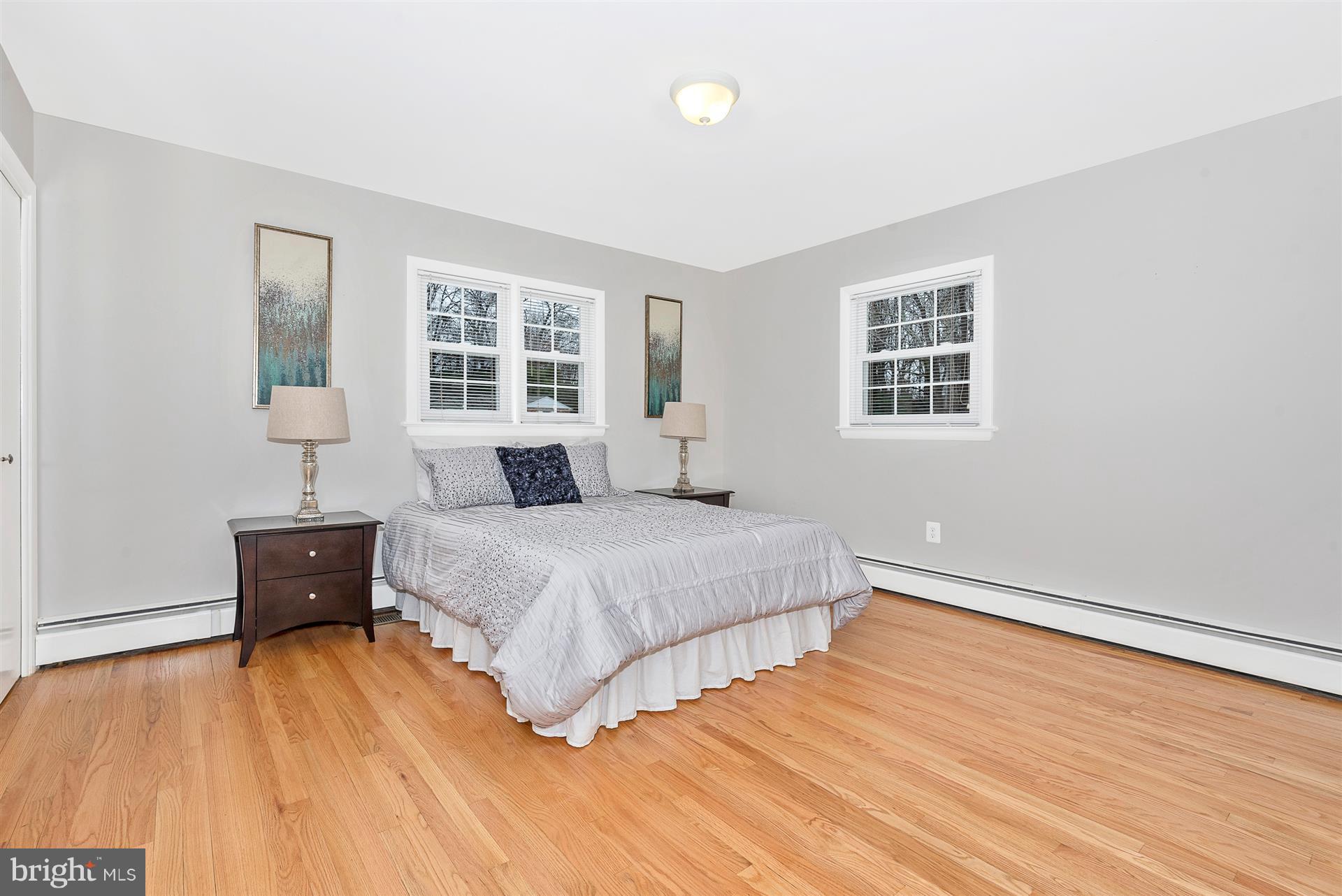 9416 Emory Grove Road Gaithersburg, MD 20877 - Photo 27 of 30 a bedroom with a bed and wooden floor