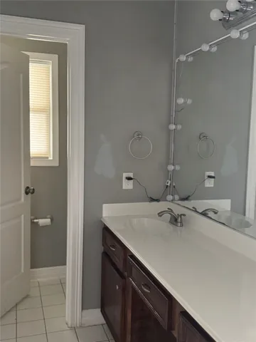 a bathroom with a sink vanity and a mirror