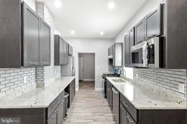 a bathroom with a granite countertop double vanity sink and mirror