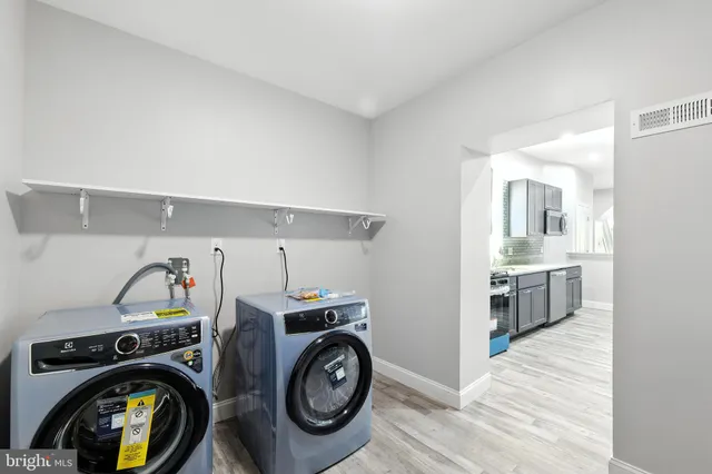 a utility room with sink dryer and washer