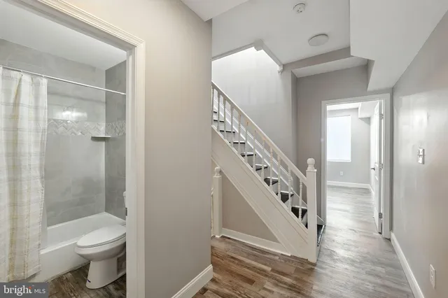 a bathroom with a toilet a sink and shower