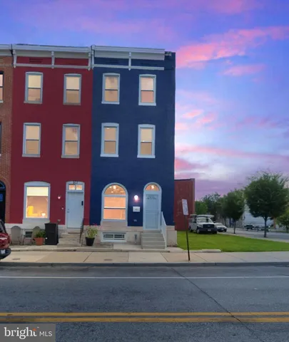 a view of a brick building next to a yard