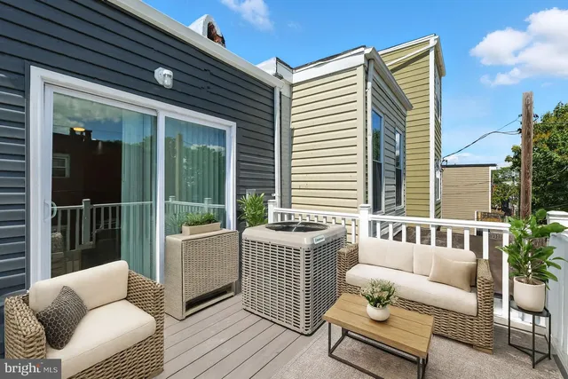 a balcony with furniture and a potted plant