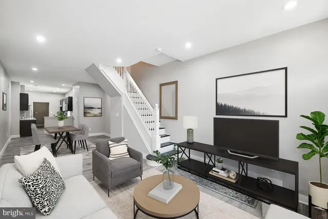 a living room with furniture a rug and a flat screen tv
