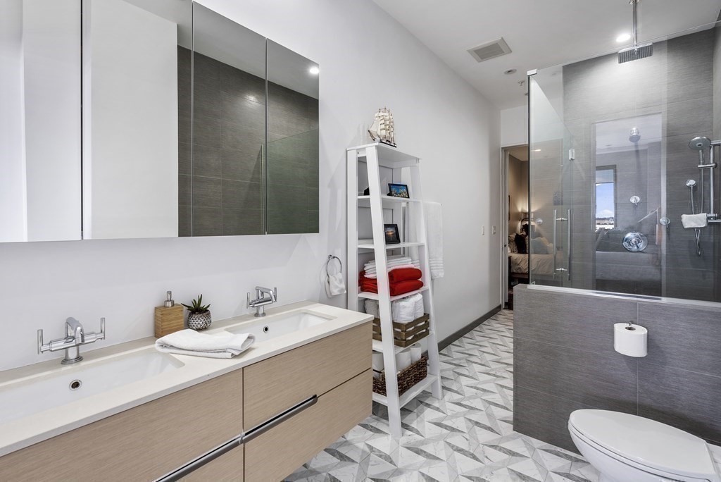 36 A, Unit 5E Boston, MA 02127 - Photo 19 of 38 a bathroom with a sink a toilet and shower