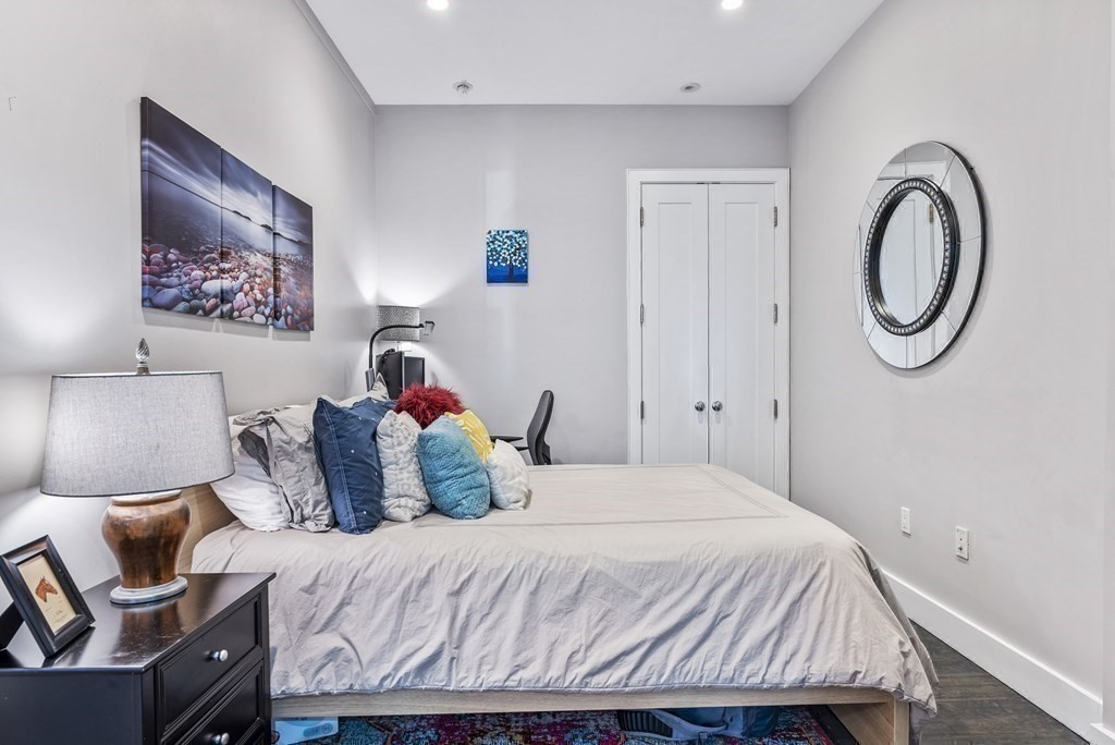 36 A, Unit 5E Boston, MA 02127 - Photo 21 of 38 a bedroom with a bed and a painting on the wall