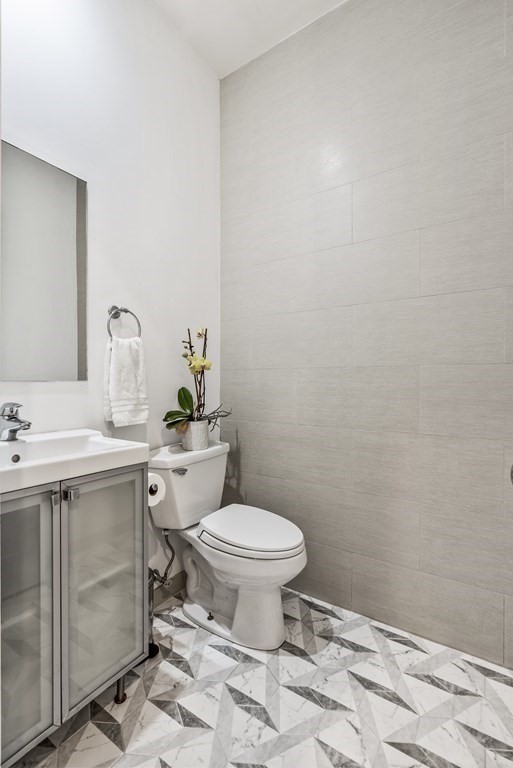 36 A, Unit 5E Boston, MA 02127 - Photo 24 of 38 a bathroom with a sink toilet and a mirror