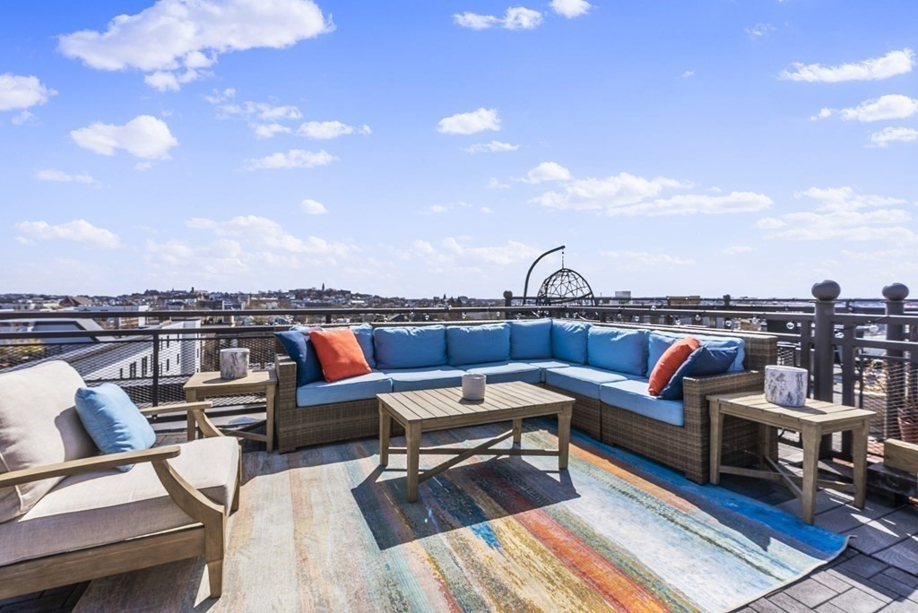 36 A, Unit 5E Boston, MA 02127 - Photo 29 of 38 a roof deck with couches and potted plants