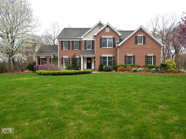 350 Flintlock Road Fairfield, CT 06890 - Photo 1 of 1 a front view of a house with a garden and trees