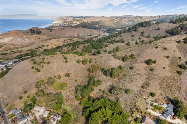 a view of a large body of water with a building in the background