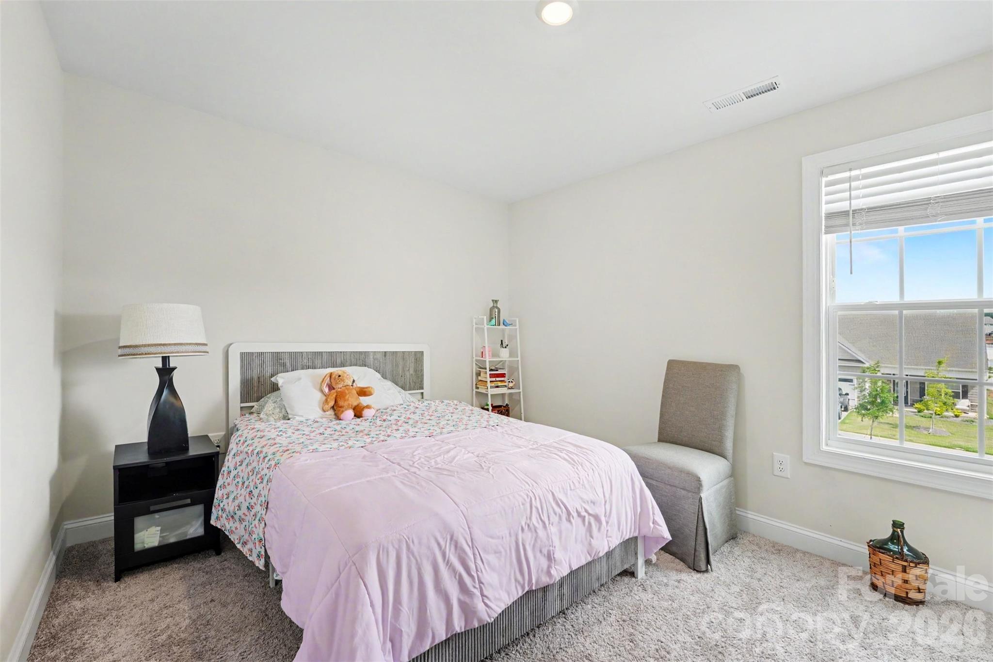 123 Brixham Loop Troutman, NC 28166 - Photo 11 of 18 a bedroom with a bed and a window
