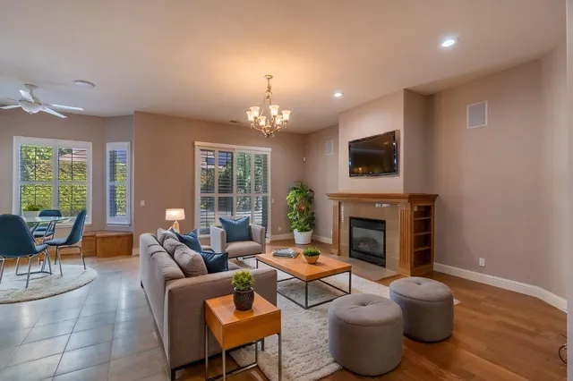 a living room with furniture a fireplace and a flat screen tv
