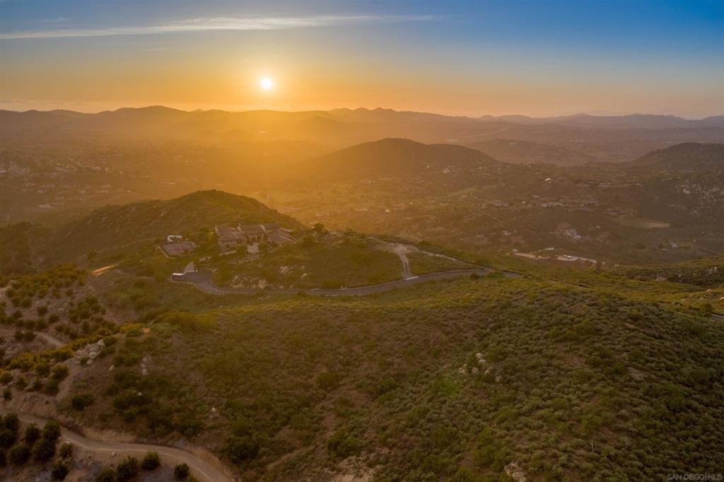 18035 Sunset Point Poway, CA 92064 - Photo 12 of 62 a view of a mountain range in a cloudy sky