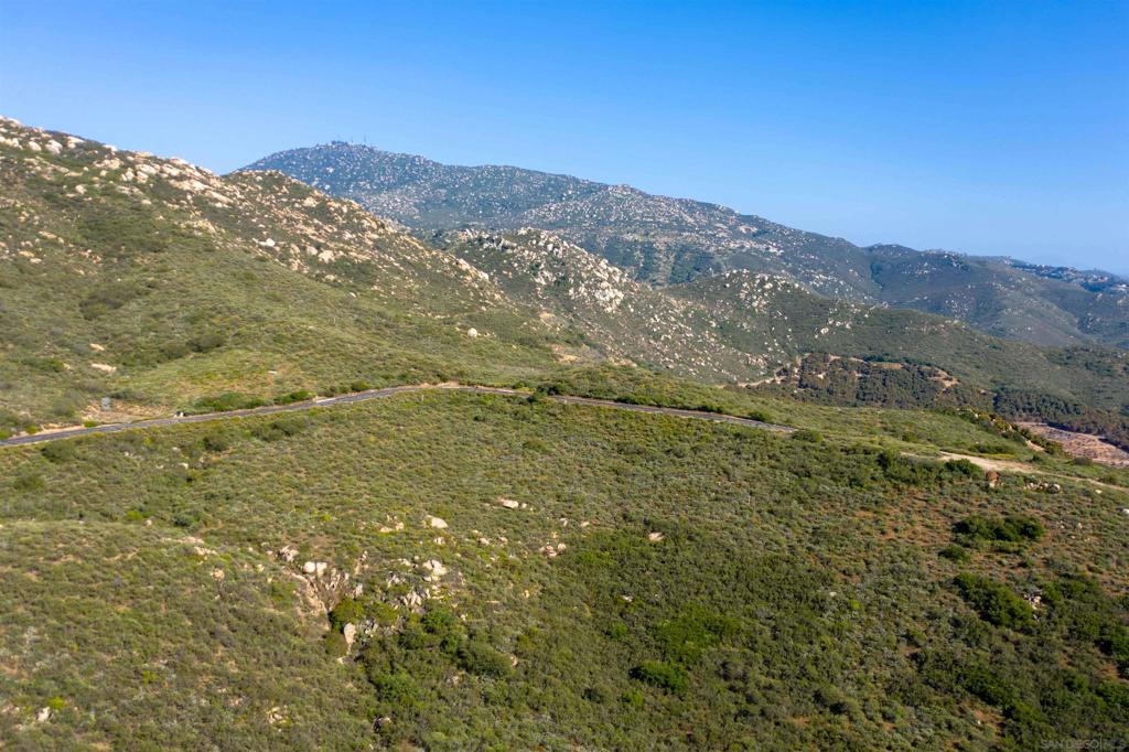 18035 Sunset Point Poway, CA 92064 - Photo 57 of 62 a view of a mountain range in a cloudy sky