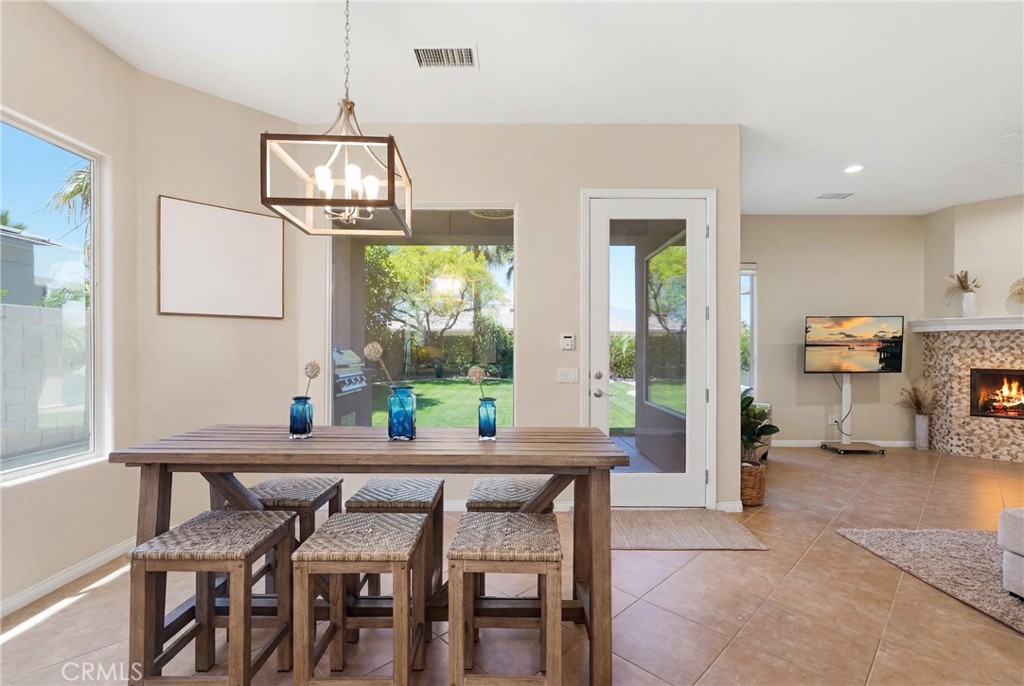 9 Orleans Road Rancho Mirage, CA 92270 - Photo 27 of 71 a dining room with furniture a chandelier and window