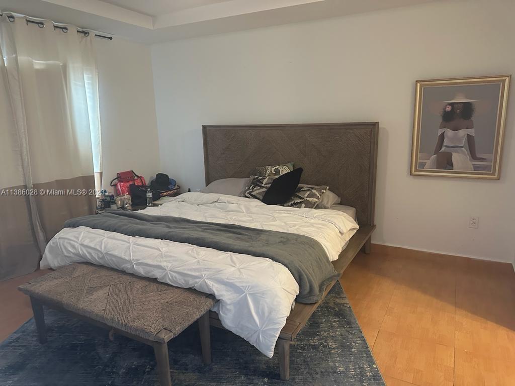 4830 Southwest 163rd Place Miami, FL 33185 - Photo 12 of 23 a bedroom with a bed and wooden floor