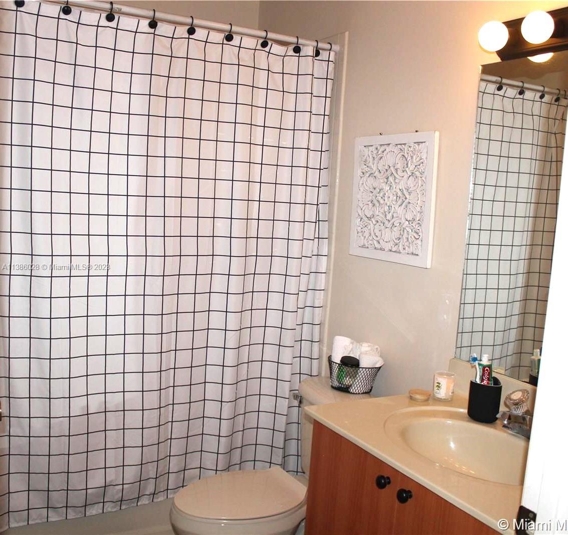 4830 Southwest 163rd Place Miami, FL 33185 - Photo 13 of 23 a bathroom with a sink a toilet and mirror