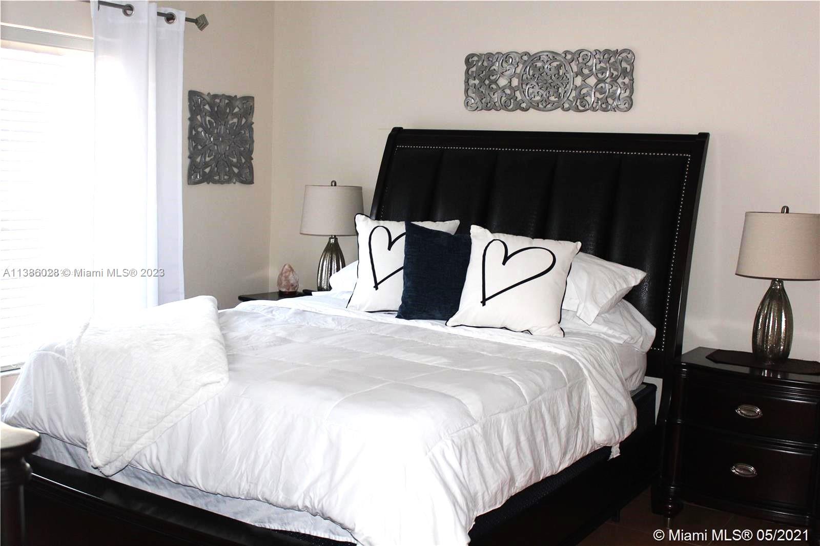 4830 Southwest 163rd Place Miami, FL 33185 - Photo 14 of 23 a bedroom with a bed and a night stand