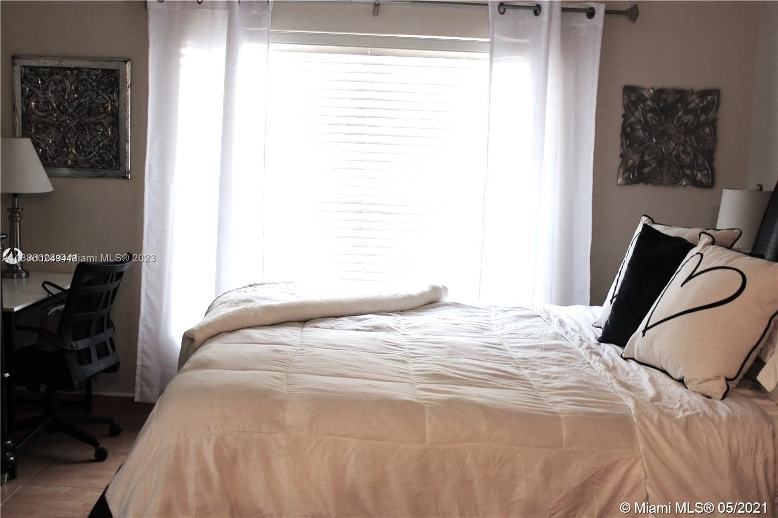 4830 Southwest 163rd Place Miami, FL 33185 - Photo 16 of 23 a bedroom with a bed and a window