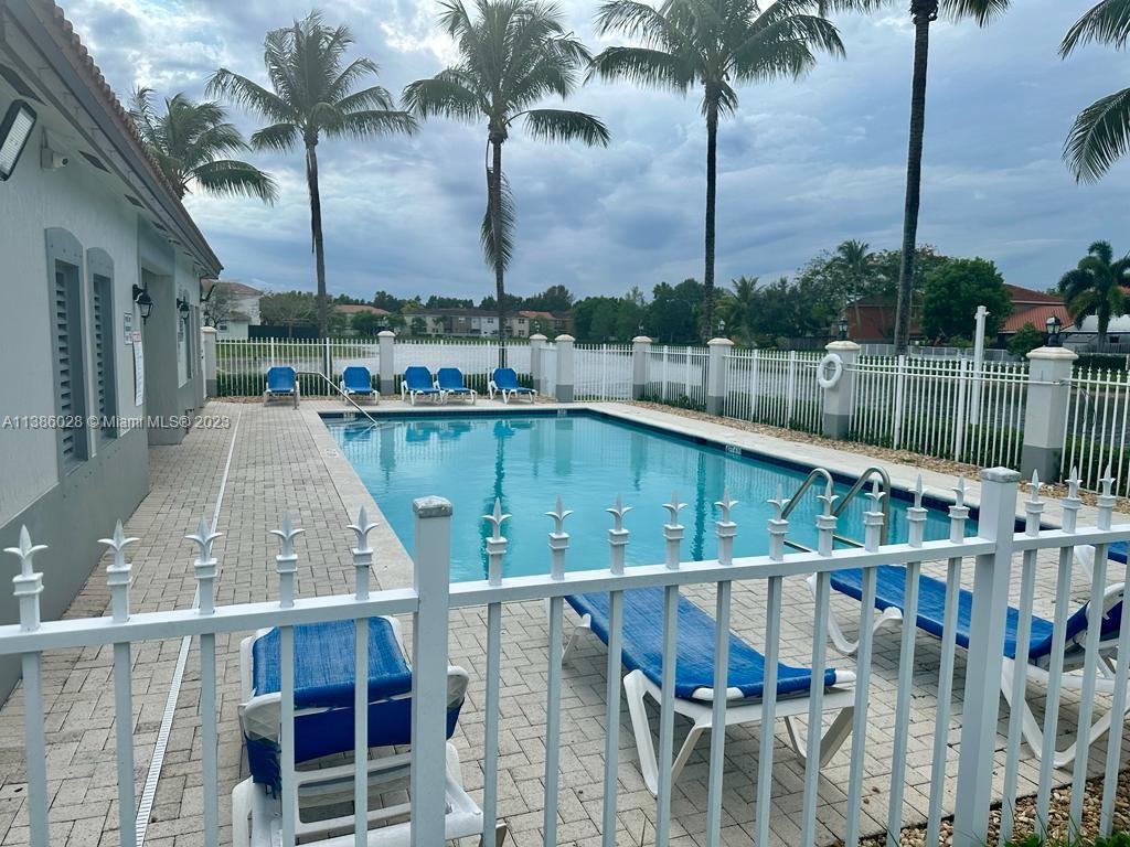 4830 Southwest 163rd Place Miami, FL 33185 - Photo 22 of 23 a view of a swimming pool with a lake and outdoor seating