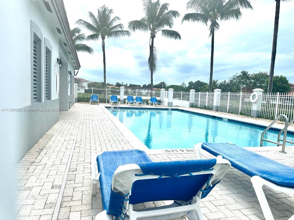 4830 Southwest 163rd Place Miami, FL 33185 - Photo 23 of 23 a view of a lake with couches chairs and wooden floor