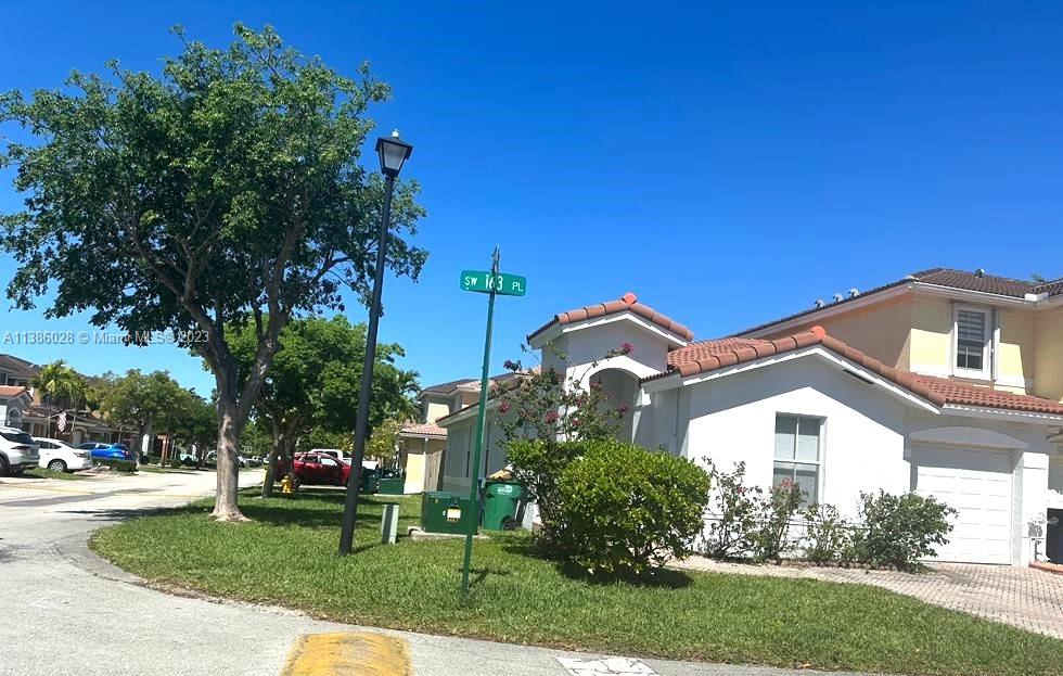 4830 Southwest 163rd Place Miami, FL 33185 - Photo 3 of 23 a front view of a house with a garden