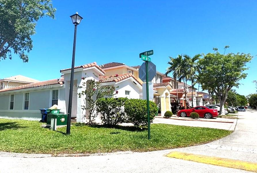 4830 Southwest 163rd Place Miami, FL 33185 - Photo 4 of 23 a front view of a house with garden