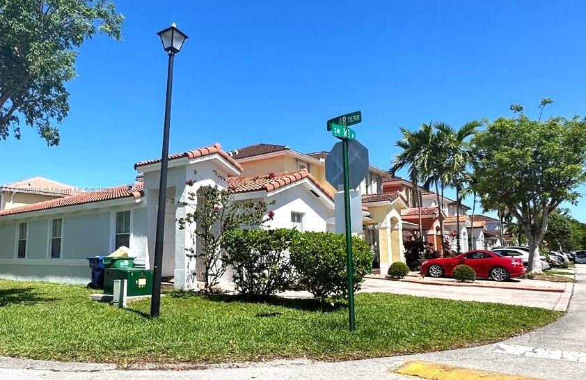4830 Southwest 163rd Place Miami, FL 33185 - Photo 5 of 23 a front view of a house with a garden