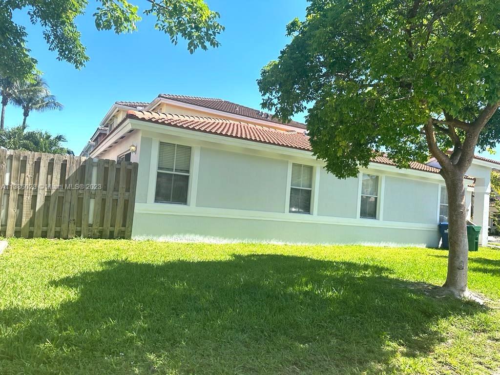 4830 Southwest 163rd Place Miami, FL 33185 - Photo 6 of 23 a front view of a house with a yard