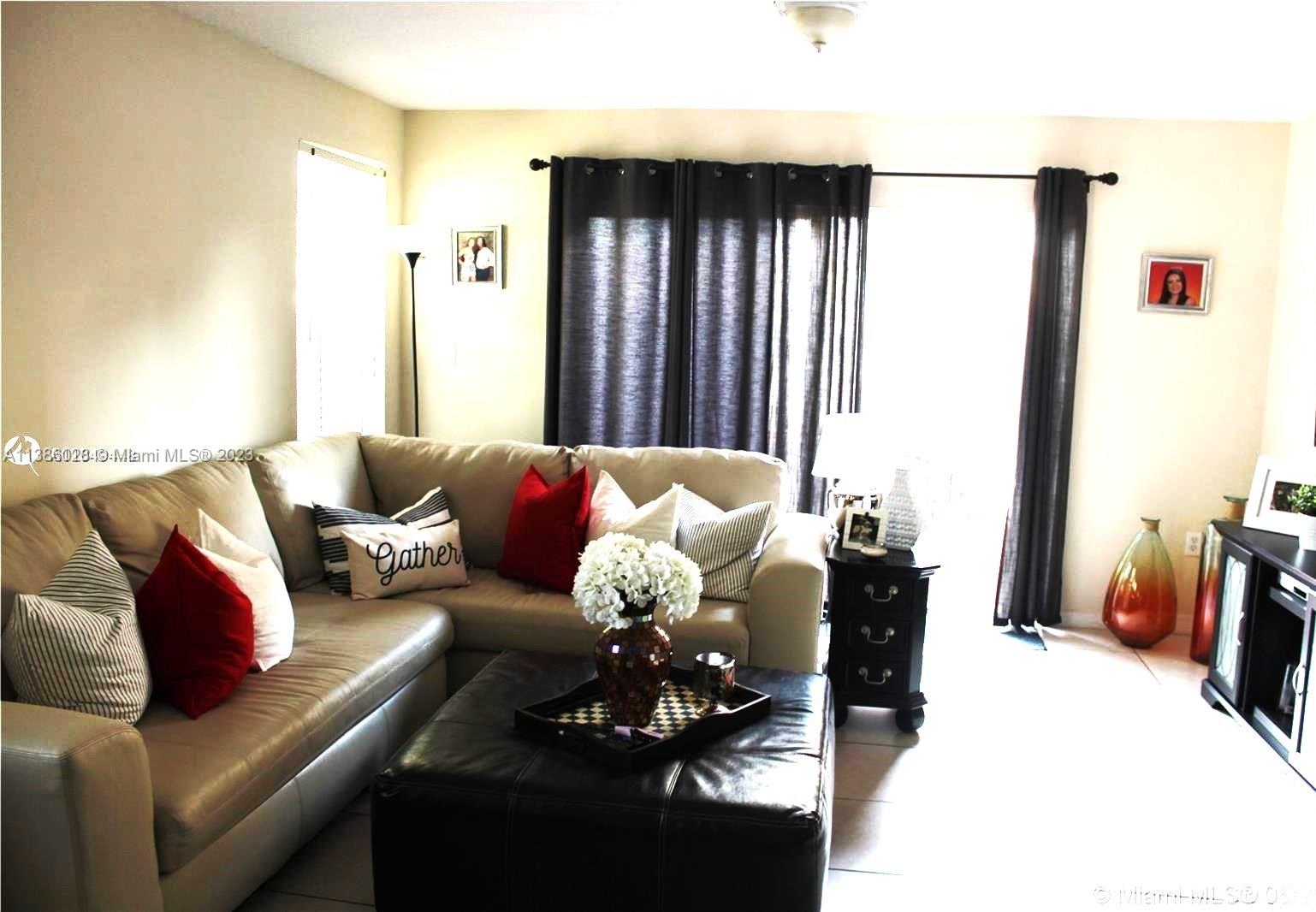 4830 Southwest 163rd Place Miami, FL 33185 - Photo 8 of 23 a living room with furniture and a large window