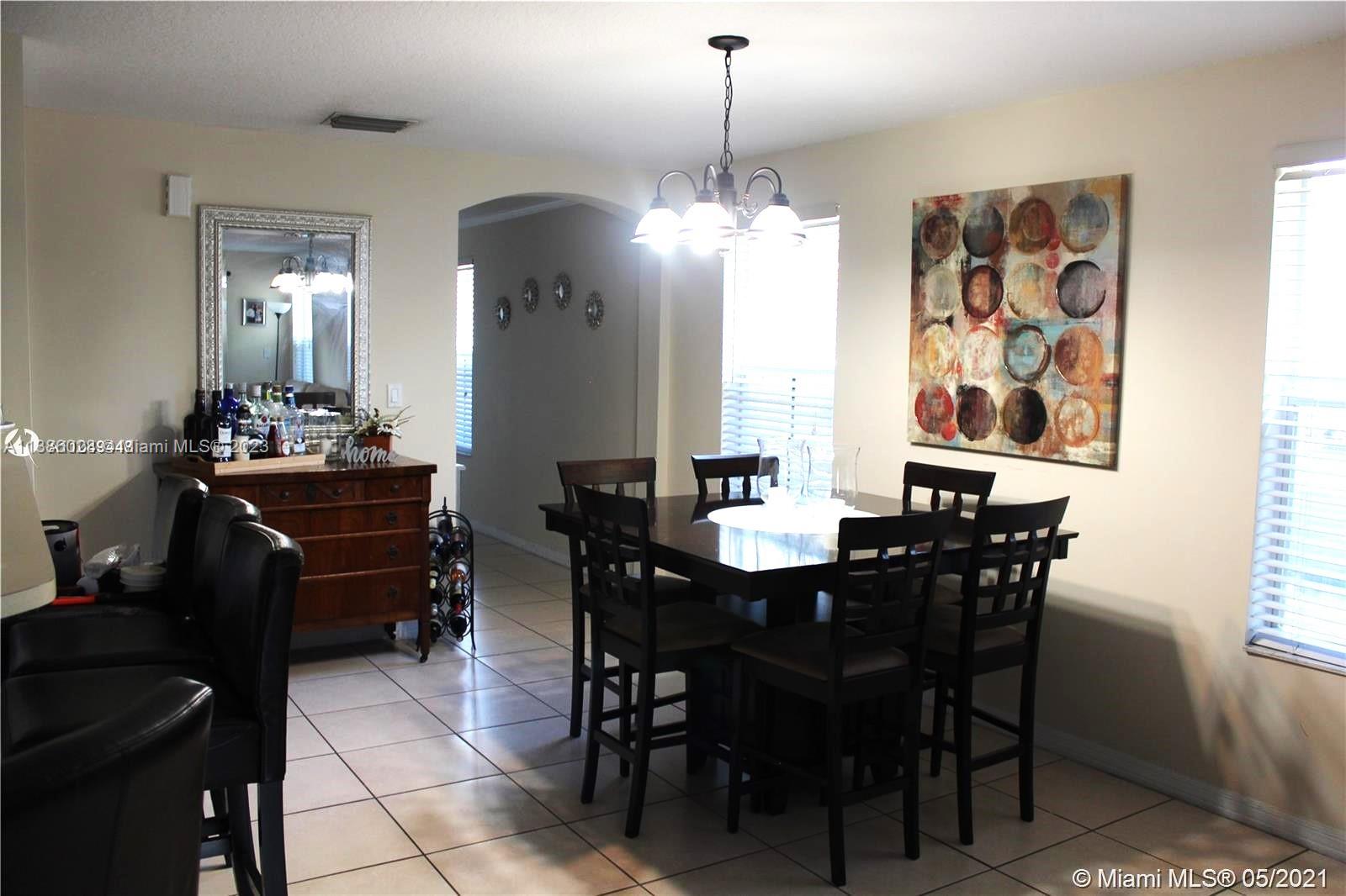 4830 Southwest 163rd Place Miami, FL 33185 - Photo 9 of 23 a view of a dining room with furniture and chandelier