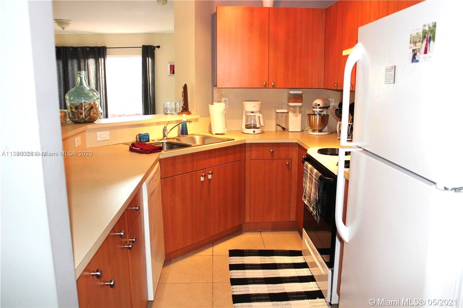 4830 Southwest 163rd Place Miami, FL 33185 - Photo 10 of 23 a view of a kitchen with kitchen island and a sink