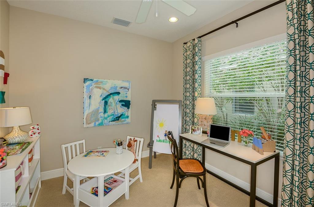 4665 Centaurus Circle Naples, FL 34120 - Photo 14 of 16 a living room with furniture and a flat screen tv