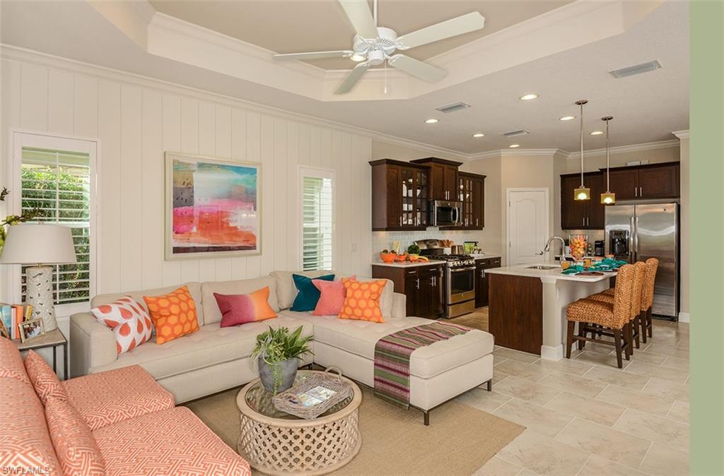 4665 Centaurus Circle Naples, FL 34120 - Photo 15 of 16 a living room with furniture kitchen view and a window