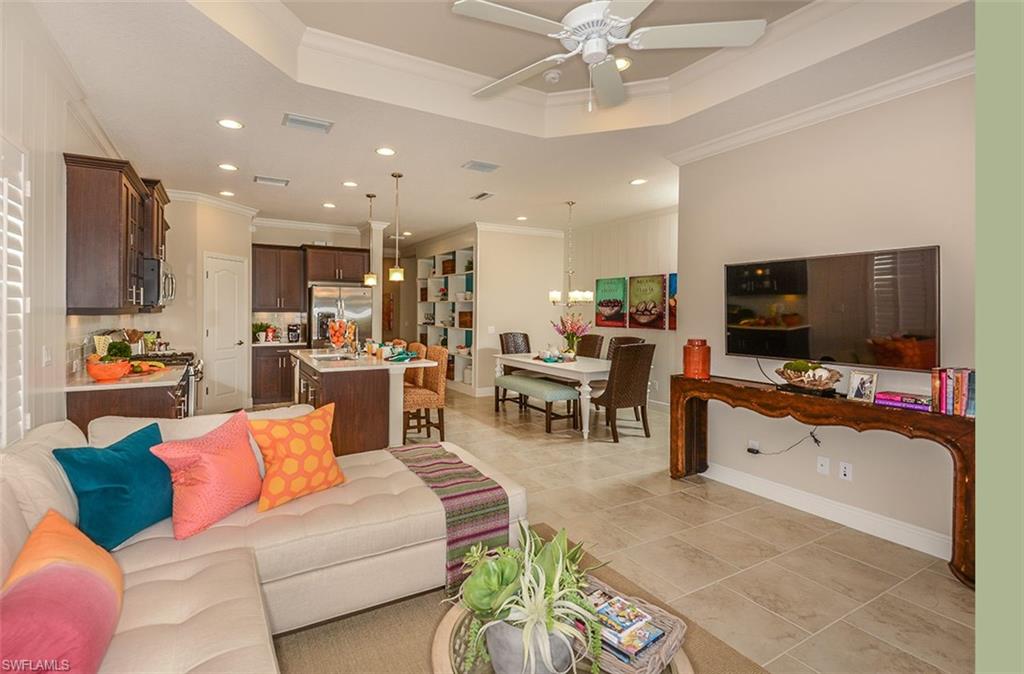 4665 Centaurus Circle Naples, FL 34120 - Photo 16 of 16 a living room with furniture and a flat screen tv